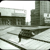 Central building : roof showing new skylight as installed (illustrating the use of the camera in job reporting), man standing on roof, view to the northeast?