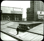 Central building : roof showing new skylight as installed (illustrating the use of the camera in job reporting), man standing on roof, view to the northeast?