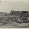 Honing and rolling earth road with dirigible hone and Buffalo Pitts macadam roller.