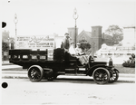 Truck with sign reading Rapid 4 Cylinder with driver and two passengers