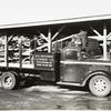 Model T 18 #C G 26  with lettering R.E. Behnke Lumber Co.; two people loading lumber