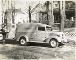Model T-14 - D-14 Man delivering flowers from truck labeled Schafers Flowers