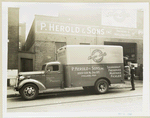Model T 16 B - D 16  people loading supplies from building labeled P. Herold & Sons Inc. 