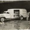 Model T 16 - A 7; people loading crates filled with bottles