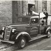 Model T 14 B - F 21 People loading truck labeled J. Kornely Hardware Co.