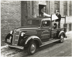 Model T 14 B - F 21 People loading truck labeled J. Kornely Hardware Co.