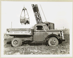 Model  T 18 HA loading onto Hyman Korman Inc. Builders truck