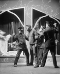 Louis Wolheim as Robert Smith "Yank" (centre) and three policemen.