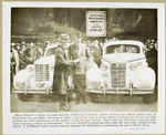 Mayor Edward J. Kelly, honorary chairman of Chicago's Charter Jubilee, receiving  Oldsmobile Six and Eight