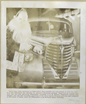 Santa Claus writes O.K. on a new Oldsmobile Six