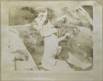 Woman with fox terrier trying to shift gears in a new Oldsmobile eight cylinder convertible coupe