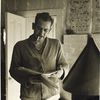 John Steinbeck with a manuscript or book
