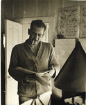 John Steinbeck with a manuscript or book