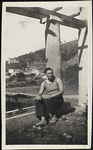 Richard Aldington seated on the base of a column