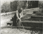 Gertrude Stein at the formal garden of her villa at Bilignin, with Pepe