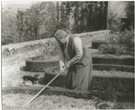 Gertrude Stein at the formal garden of her villa at Bilignin, with Pepe