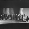 Setting designed by Jo Mielziner for Shaw's "Pygmalion" produced and presented by the Theatre Guild, NYC: 1926. Lynn Fontanne as Eliza Doolittle (5th from left, seated), Reginald Mason as Professor Higgins (holding book) and J.W. Austin as Colonel Pickering (extreme right), et al.