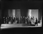Setting designed by Jo Mielziner for Shaw's "Pygmalion" produced and presented by the Theatre Guild, NYC: 1926. Lynn Fontanne as Eliza Doolittle (5th from left, seated), Reginald Mason as Professor Higgins (holding book) and J.W. Austin as Colonel Pickering (extreme right), et al.