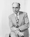 Potrair of Kurt Weill (with spectacles, tie, hands folded in lap)