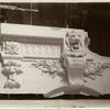 Plaster model of architectural detail above an arch, including moldings, a keystone decorated with a volute, and a lion's head.]