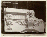 Plaster model of architectural detail above an arch, including moldings, a keystone decorated with a volute, and a lion's head