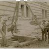 Exterior marble work : men flanking a piece of marble being hoisted