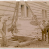 Exterior marble work : men flanking a piece of marble being hoisted