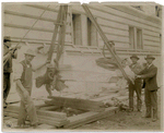 Exterior marble work : men flanking a piece of marble being hoisted