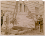 Exterior marble work : men flanking a piece of marble being hoisted