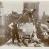 Exterior marble work : construction workers positioning a piece of marble on the roof, looking east