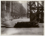 Interior work : west brick wall, with bases for supporting poles in foreground