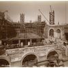 Interior work : view of workers laying bricks, from on top of the Fifth Avenue facade, looking west
