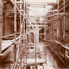 Interior work : wooden scaffolding along two brick walls