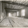 Interior work : construction of a room, showing the completed brickwork of the walls, windows and ceiling