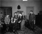 The Stokmann family "at home". Walter Hampden (Dr. Stockmann), Mabel Moore (Mrs. Stockmann), C. Norman Hammond as Peter Stockmann, extreme right, appearing in "An enemy of the people", NYC: Hampden Theatre.