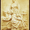 Portrait of unidentified young woman in plaid dress and hat.