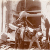 Group of workers tying ropes around a block of marble