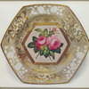 Hexagonal plate. (With three transverse indentations dividing border into six compartments. The central panel with deep gold frame decorated with roses in the Billingsley manner. Border decorated with floral sprays gilded, and in white in relief. Marked "SPODE" 2057 in red.)