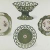 Examples from two Apple Green Spode Services. Dessert Dish with rosettes and banded ornament in relief and Plate with miniature medallion in colours and border with cut open-work designes. (Portion of service, marked "SPODE" in green given by Josiah Spode to William Taylor Copeland on his marriage in 1826.) Dishes with sprays of flowers painted in natural colours and gilded. Borders ornamented by floral sprays in white and in relief. (Portion of another service.) Marked "Felspar Porcelain," with wreath and 3899 in puce