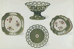 Examples from two Apple Green Spode Services. Dessert Dish with rosettes and banded ornament in relief and Plate with miniature medallion in colours and border with cut open-work designes. (Portion of service, marked "SPODE" in green given by Josiah Spode to William Taylor Copeland on his marriage in 1826.) Dishes with sprays of flowers painted in natural colours and gilded. Borders ornamented by floral sprays in white and in relief. (Portion of another service.) Marked "Felspar Porcelain," with wreath and 3899 in puce