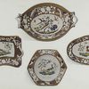 Group: Portion of an Old Spode Dinner Service. Decorated with exotic birds in brilliant colours. The borders of a warm buff colour are ornamented with birds' feathers in natural colours and with sprays of flowers in white in relief. This service was used at the Ministerial annual whitebait dinners by members of the government at the old Ship Inn at Greenwich. Marked "SPODE" 2102, some pieces in black but mostly in red