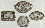 Group: Portion of an Old Spode Dinner Service. Decorated with exotic birds in brilliant colours. The borders of a warm buff colour are ornamented with birds' feathers in natural colours and with sprays of flowers in white in relief. This service was used at the Ministerial annual whitebait dinners by members of the government at the old Ship Inn at Greenwich. Marked "SPODE" 2102, some pieces in black but mostly in red