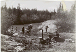 Packing on the first portage, Slave River.