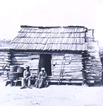 Slaves in front of a cabin