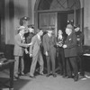 Scene from The Front Page (by) Hecht & MacArthur. NYC.1928. Osgood Perkins as Walter Burns (extreme left wearing homburg) and Lee Tracy (Hildy Johnson) 3rd from left, next to policeman, without hat.