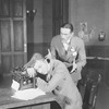 Osgood Perkins (standing) as Walter Burns and Lee Tracy (seated) as Hildy Johnson, Herald-Examiner.