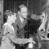 Kay Swift (composer, at piano) together with Paul James, (lyricist) at a rehearsal for Joe Cook's Fine and Dandy. NYC: 1930.