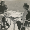 Margaret Sullavan and Leland Hayward outside at table