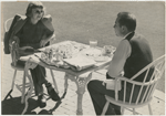 Margaret Sullavan and Leland Hayward outside at table