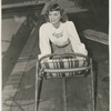 Margaret Sullavan leans on bamboo chair